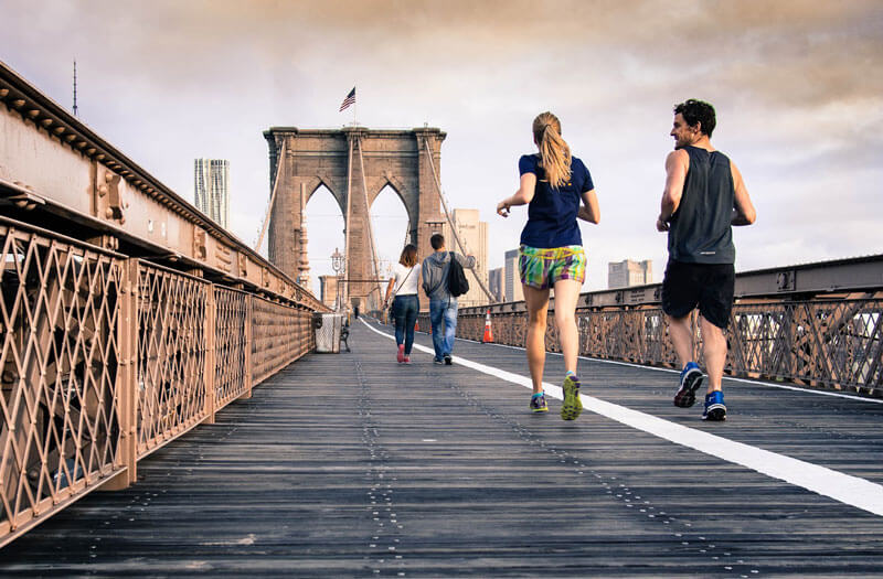 two people running on bridge